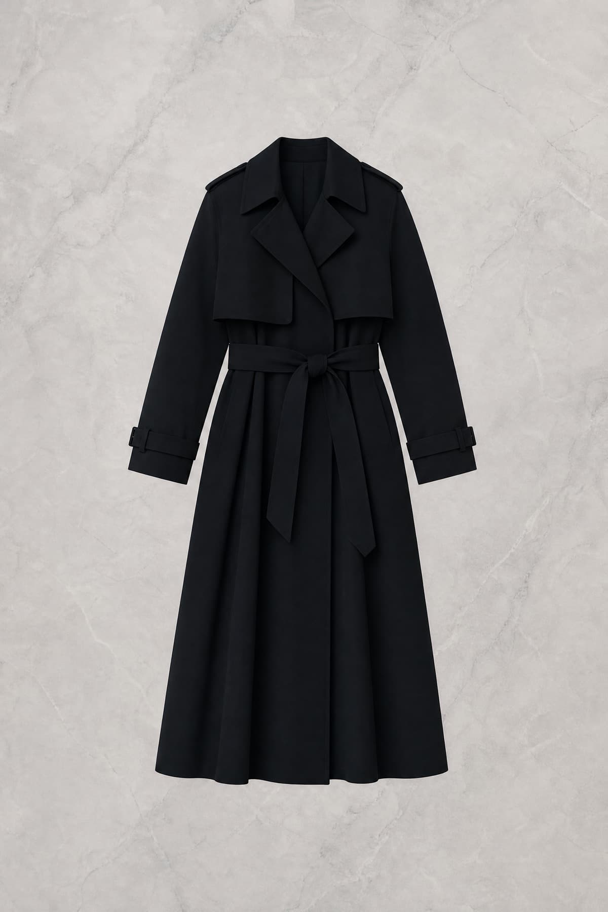 Front silhouette of a belted trench coat falling in heavy vertical folds