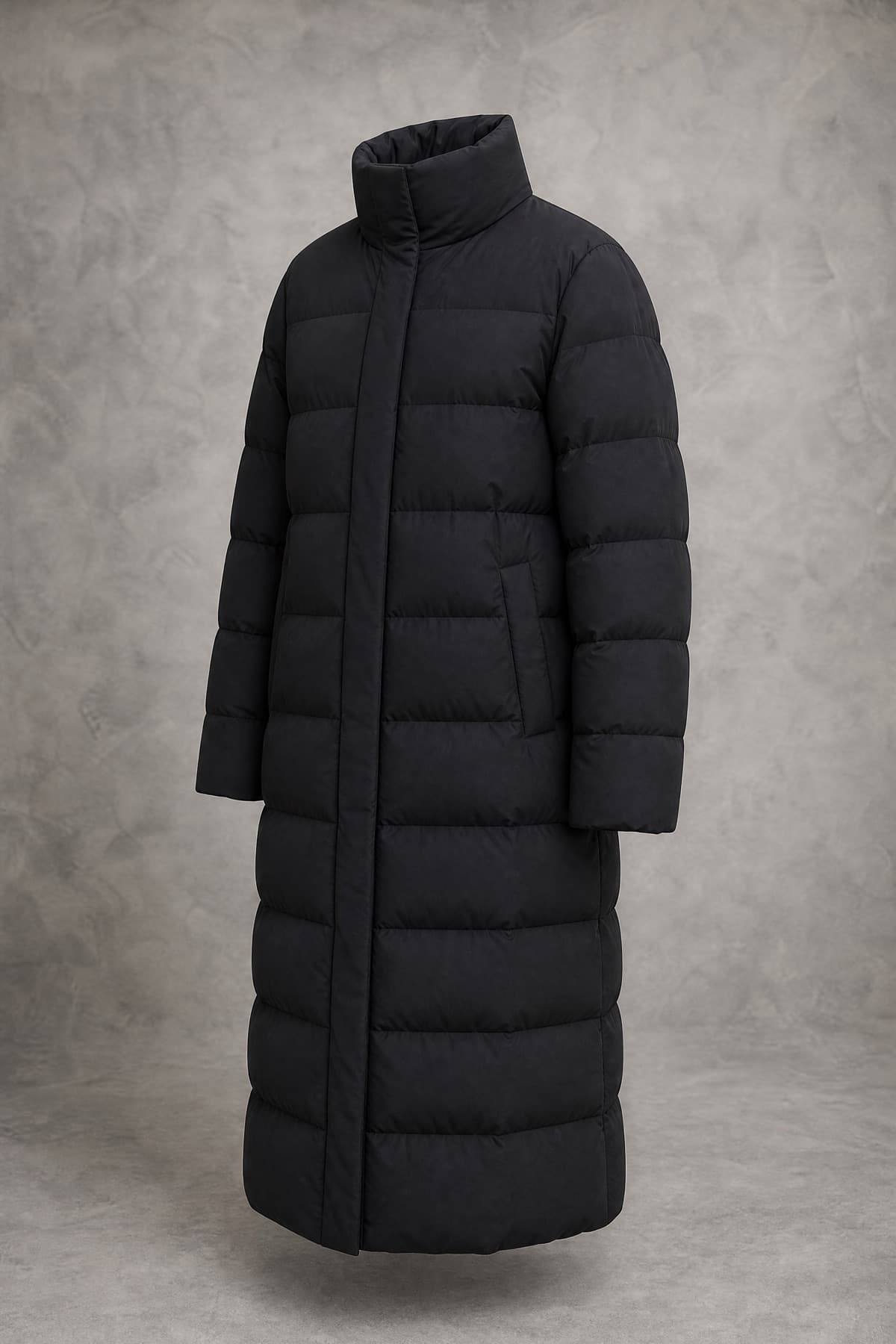 A long matte black down coat with deep box-baffle chambers